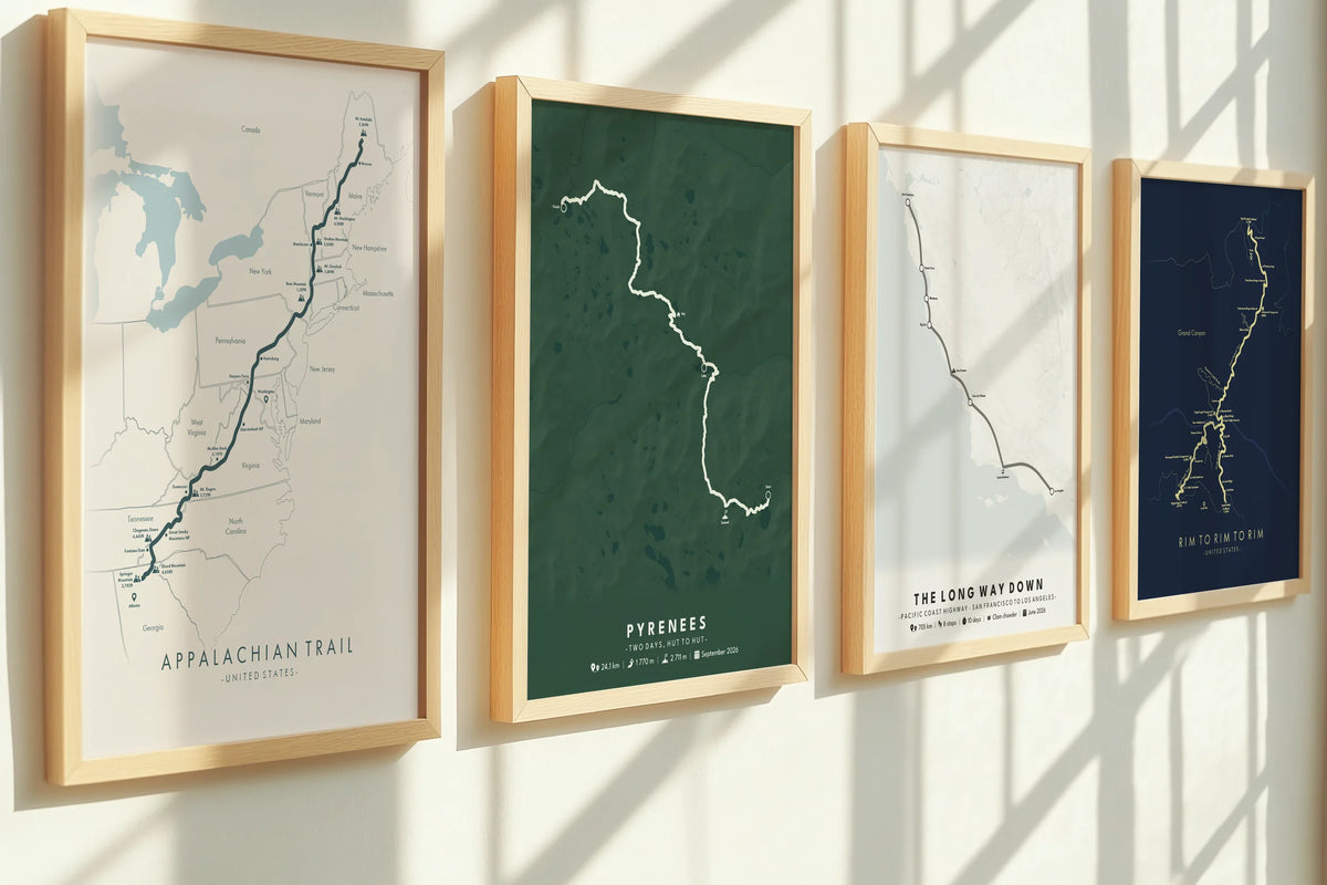Custom map prints of a hike, a road trip and a canyon trail, framed on a wall